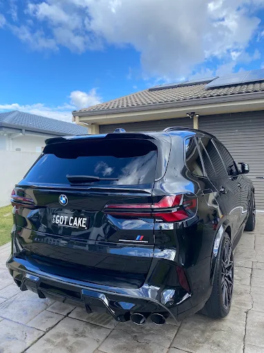 Gloss black BMW X5 M detailed in a Gold Coast driveway